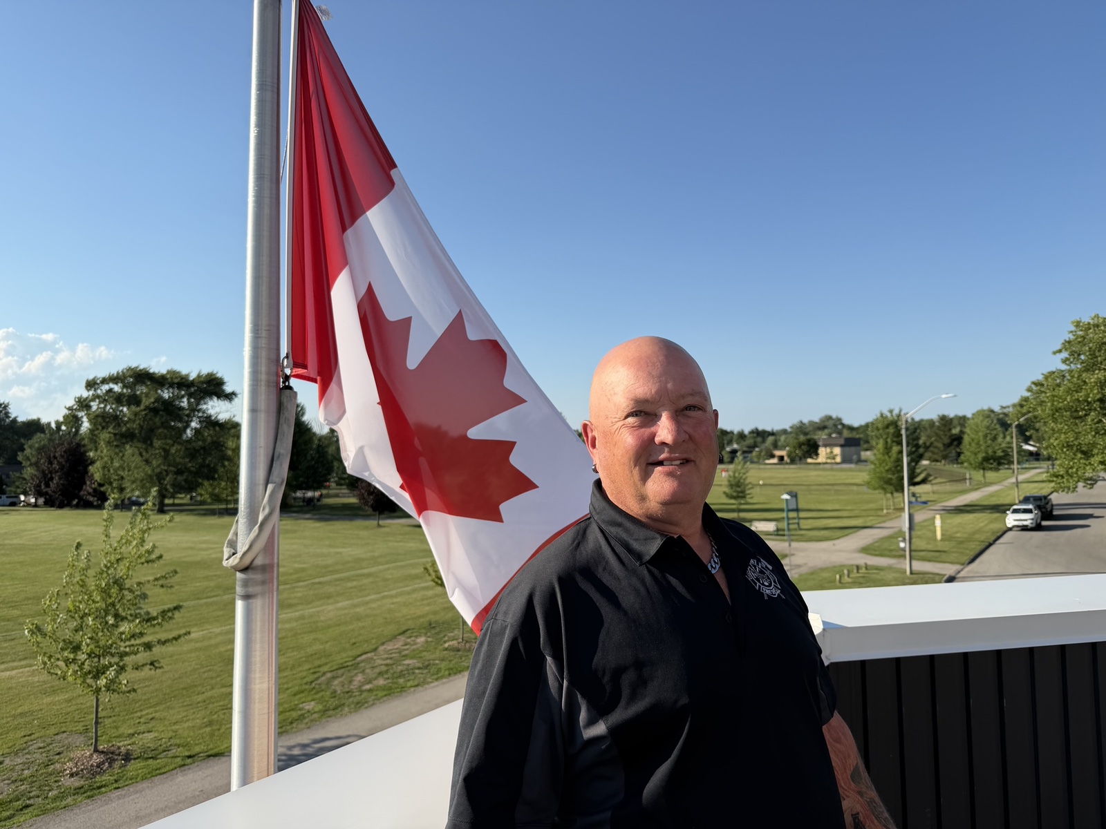 Brian Winrow standing near a Canadian flag in Niagara Falls